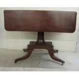 A late 19thC mahogany Pembroke table, raised on an octagonal column and splayed quadruped base