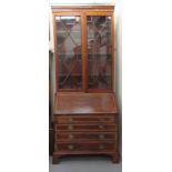 An Edwardian crossbanded string and ebony inlaid mahogany bureau bookcase, the cornice over a pair