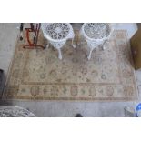 A Pakistan rug, decorated with floral designs in pastel tones, on a cream coloured ground  49" x 84"