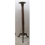 An early 20thC floral carved mahogany torchere, on a splayed tripod base  54"h