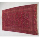 A Bokhara rug, decorated with elephant foot motifs, on a red ground  72" x 44"