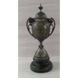 A late Victorian twin handled silver plated lidded trophy, presented by Lieutenant A Stewart, 5th
