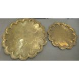 A Middle Eastern engraved brass tray with a raised, lobed border  28"dia; and another similar  19"