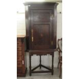 A George III oak corner cupboard, on a stand  71"h overall  33"w