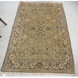 A Persian rug, decorated with dense floral and bird motifs, on a beige ground  80" x 52"