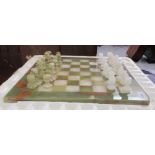 A modern marble chess set with carved and turned pieces, on an attendant board  16"sq  the kings 2.