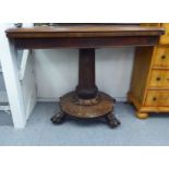 A William IV rosewood card table, the rotating foldover top raised on a turned pedestal and circular