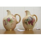 A pair of Royal Worcester blush ivory glazed and gilded china flatback jugs, decorated with mixed