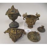 A pair of late 19thC gilt metal sidepiece pedestal urns and covers, cast in high relief with