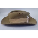 A 1943 dated khaki felt hat with a woven cloth parachute badge  (Please Note: this lot is subject to