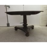 A William IV mahogany breakfast table, the tip top over a turned cannon barrel column, raised on