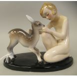 An Art Deco Goldscheider, Claire Weiss porcelain group, a girl kneeling with a fawn, on an oval base