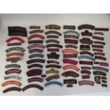 Approx. seventy cloth military shoulder titles: to include Royal Army Service Corps  (Please Note: