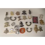 Approx. twenty-two, mainly Welsh regiment cap badges and other insignia, some copies: to include