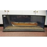 A table-top model, a clinker built rowing boat with oars, total length 27" in a glazed case  14"h