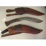 A kukri with a rivetted hardwood handle, the blade bears stamped numerals and letters  12.5"L in a