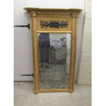 A late Regency pier glass, set in an inverted breakfront, carved giltwood frame with ball ornament