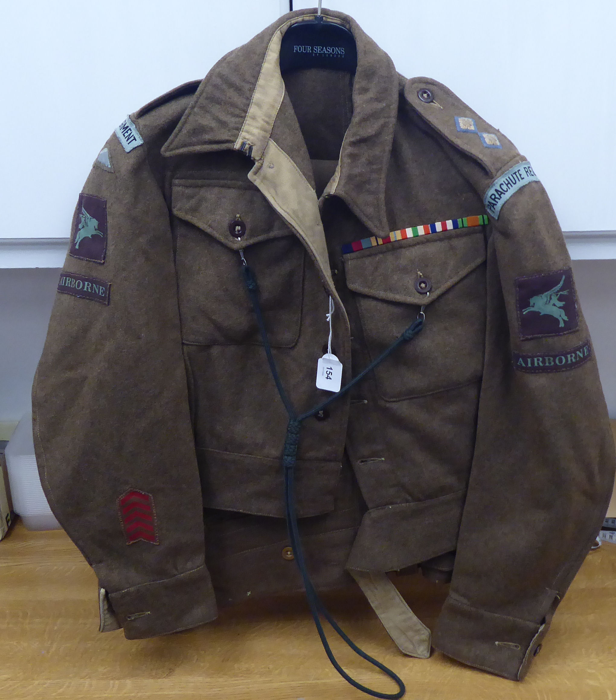 A 1943 dated British Parachute Regiment officers battledress with a lanyard and a pair of