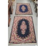 A pair of Persian design rugs, decorated with floral motifs, on a blue ground  36" x 60"