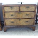 A George III walnut veneered dressing chest with two short/two long drawers, raised on bracket feet