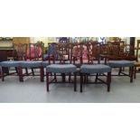 A set of eight Chippendale design mahogany framed dining chairs, each with a pierced and carved