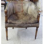 An early 20thC Regency design mahogany framed tub style library chair, stud upholstered in tan hide,