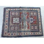 A Persian prayer rug with stylised motifs, on a blue and red ground  40" x 50"