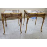 A pair of modern bamboo and cane conservatory tables, each with a glass top, raised on splayed legs