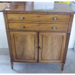 A Regency mahogany side cabinet with two drawers and two doors, raised on turned legs  35"h  30"w