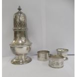 Silver collectables: to include a caster and three dissimilar napkin rings  mixed marks