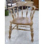 A mid 20thC oak and elm framed smokers bow with a solid seat raised on turned legs