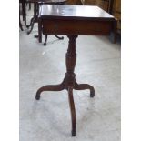 A Regency mahogany work table with fall flaps and a drawer, raised on a tripod base  28"h  14"w