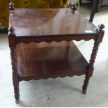 A late Victorian mahogany two tier side table, raised on casters  19"h  20"w