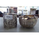 A silver tea caddy, decorated with a period Roman village scene  indistinct marks; and a silver bowl