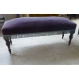 A late Victorian Gothic inspired oak framed window seat with a maroon fabric upholstered top, raised