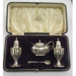 A set of three George V silver condiments   Sheffield 1915  cased