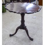 A George III mahogany pedestal table, the top with a piecrust moulded edge, raised on a cabriole