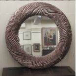 A modern mirror, set in a swirling bark design frame  38"dia overall