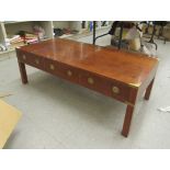 A modern military design brass bound yewwood coffee table, raised on square legs  16"h  48"w