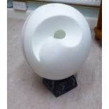 A modern abstract design marble ball sculpture, on a plinth  15"L overall