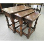 A nesting set of three 20thC Old English style, stained oak occasional tables  largest 17"h  20"w