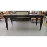 A late Victorian mahogany wind-out dining table, raised on tapered, reeded legs and brass sabots and