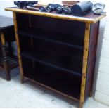 A late 19thC bamboo framed and foliate embossed, panelled, three tier open front bookcase  33"h