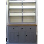 An early 20thC later painted grey, pine kitchen dresser, the upper section comprising three open