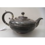 A William IV silver teapot of squat, oval form with a scrolled handle  London 1830