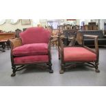 A pair of early 20thC bergere chairs (one restored), raised on carved block legs united by