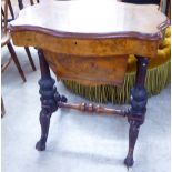 A late Victorian walnut serpentine front sewing table, the hinged lid enclosing a fitted interior,