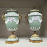A pair of Wedgwood green Jasperware and gilt metal mounted pedestal urn and cover, decorated