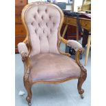 A late Victorian walnut framed spoonback salon chair, upholstered in pink fabric with swept open