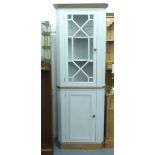 A modern part grey/cream coloured painted pine corner cupboard, comprising an astragal glazed